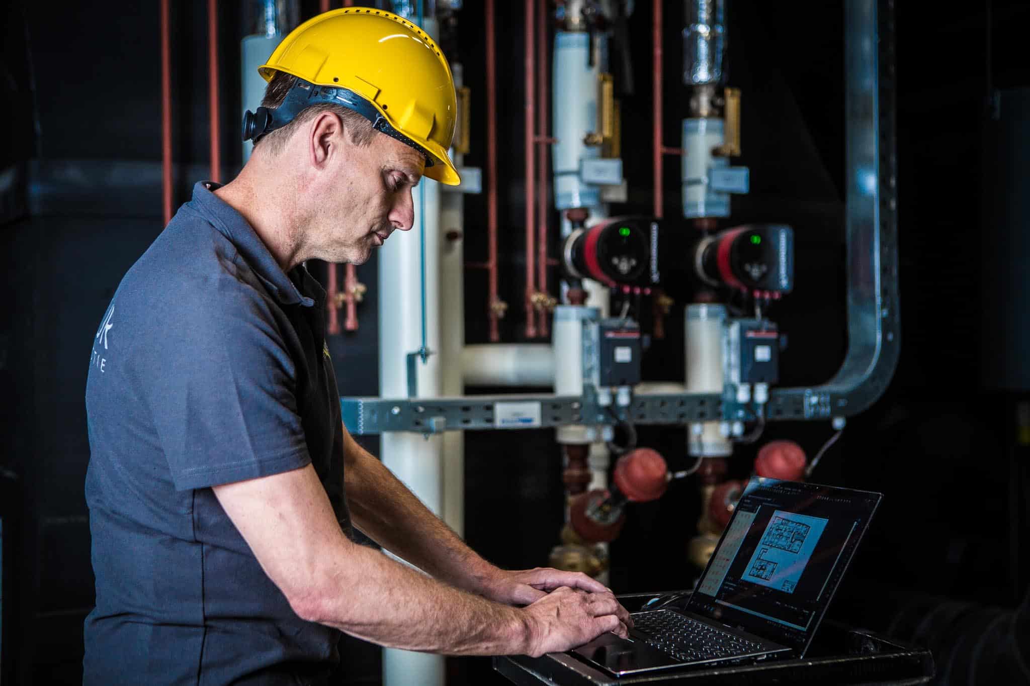 Construction worker using a laptop at the job site