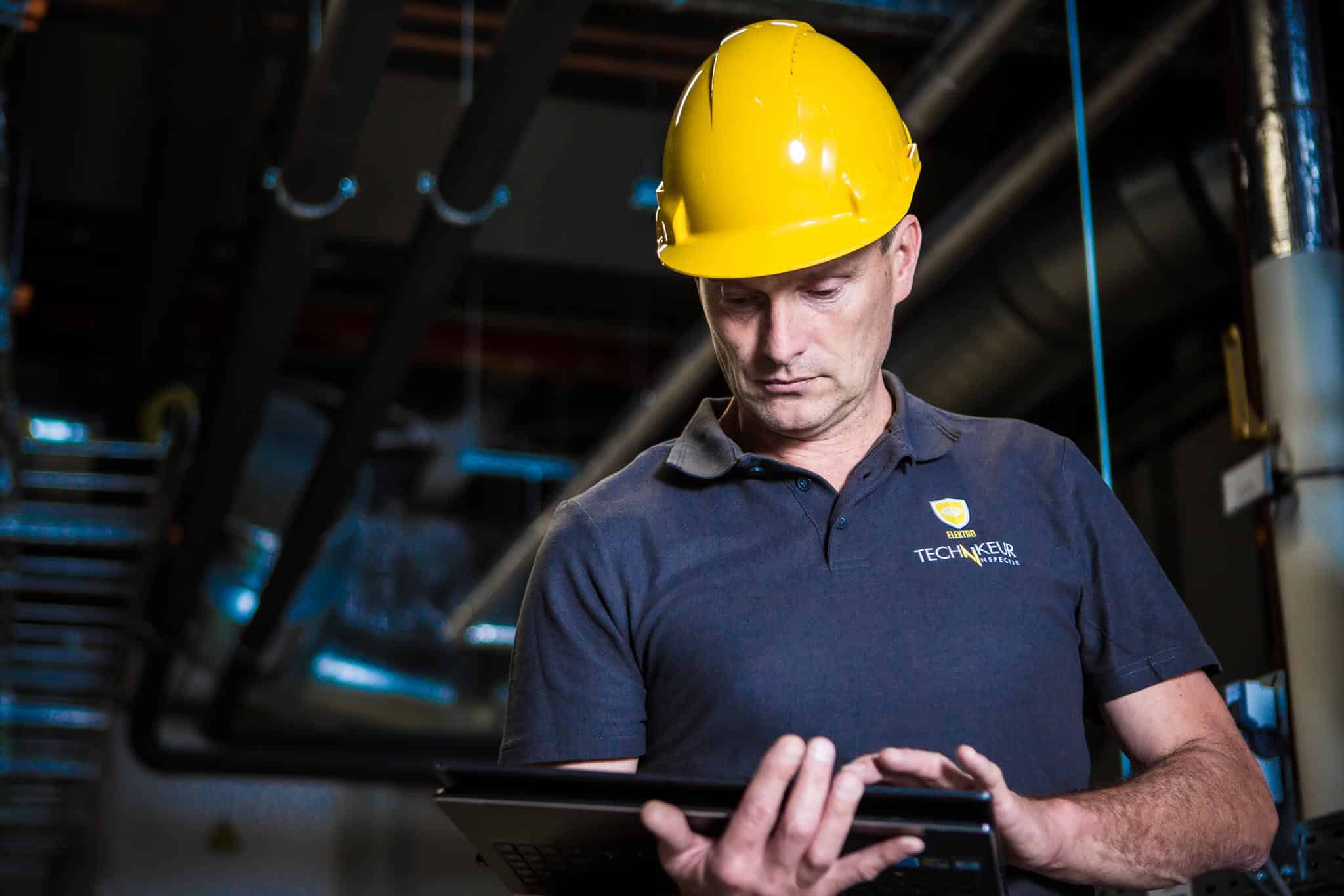 Construction worker on a job site looks down at a tablet