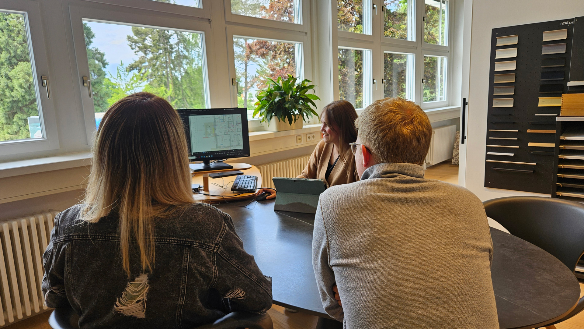 SchwörerHaus employees at conference room table looking at monitor with Revu