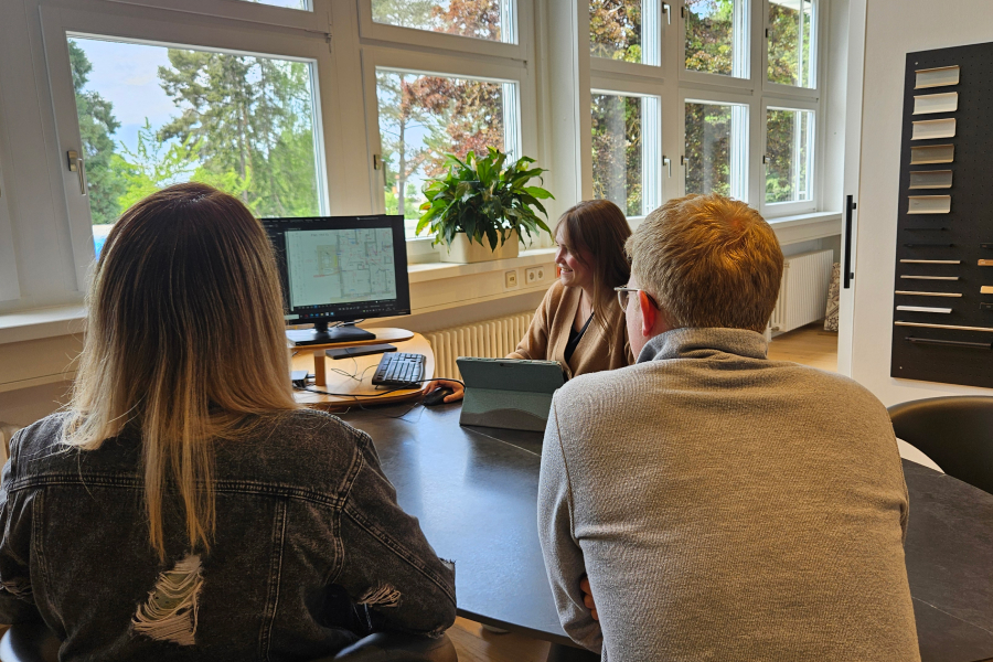 SchwörerHaus employees at conference room table looking at monitor with Revu