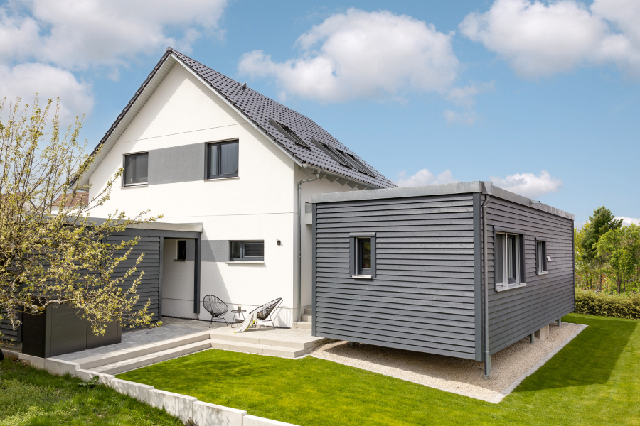 Exterior shot of a house with a separate building in the backyard
