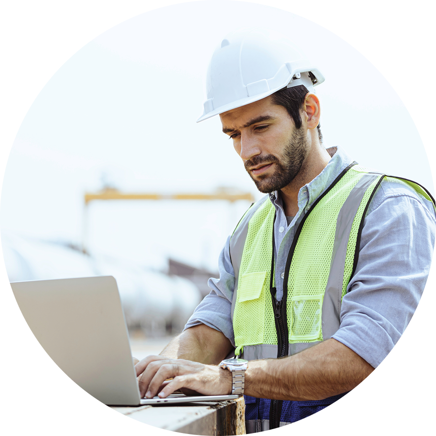 Construction worker uses laptop on jobsite