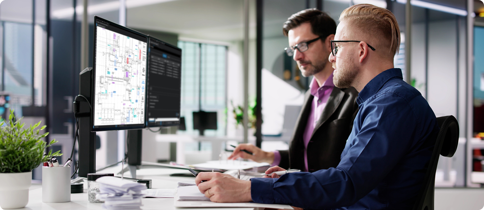  Two professionals look at Bluebeam Revu on desktop 