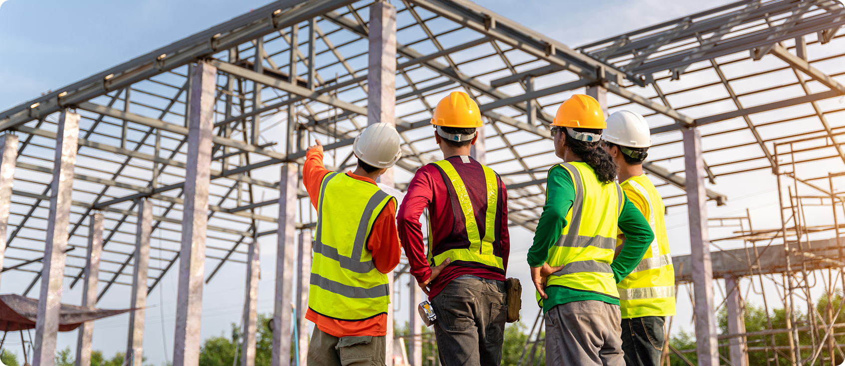  Construction worker points out something at job site to coworkers 