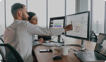 Office worker points out something in Revu to colleague