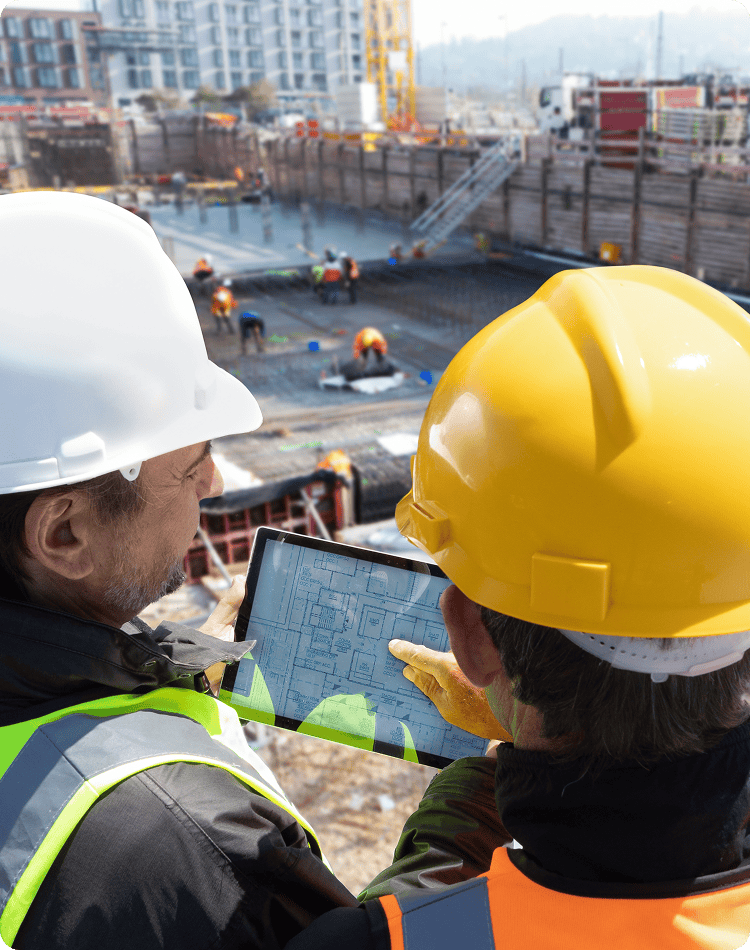 Construction workers looking at a laptop