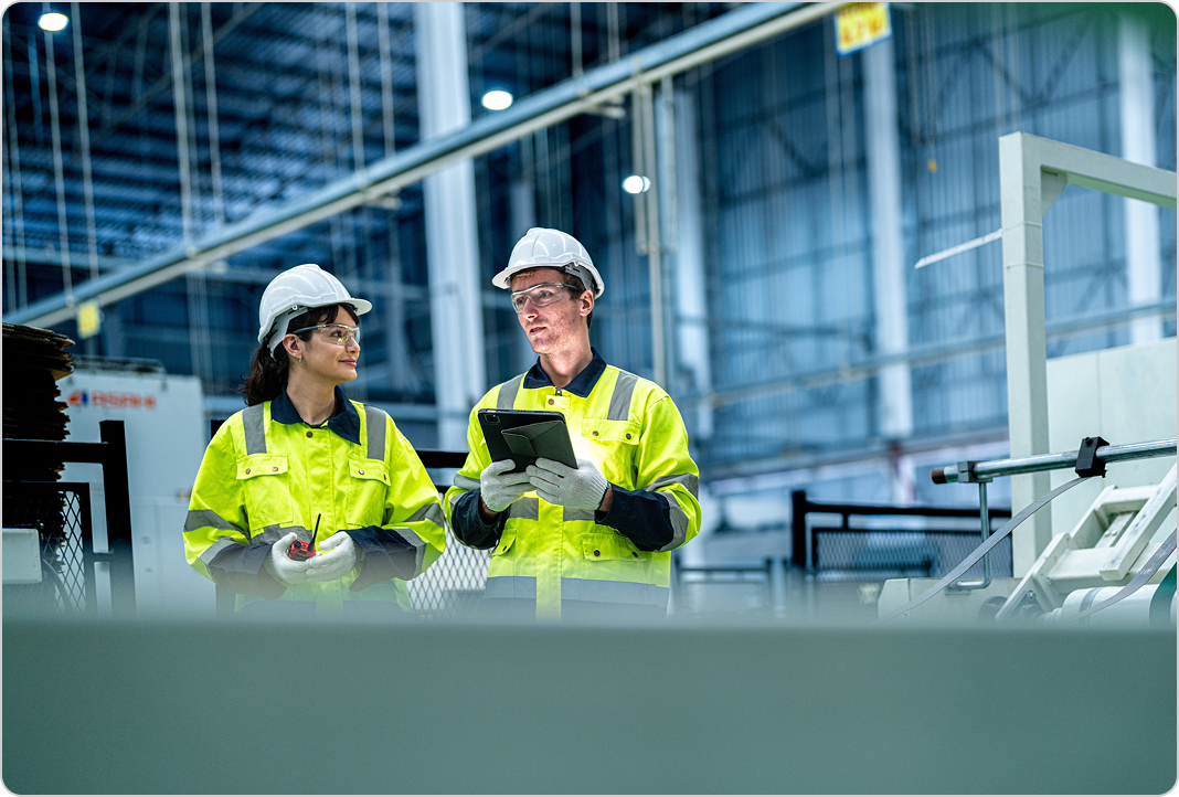 Mechanical engineers working together in industrial building