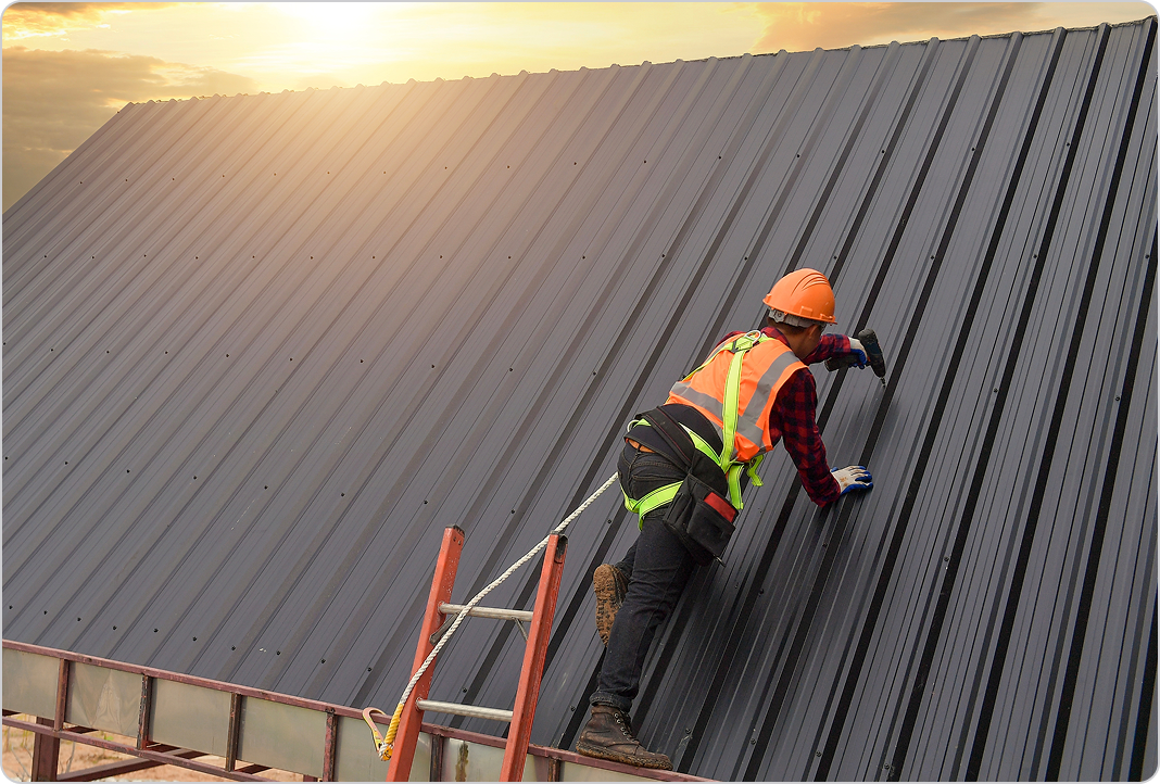 Roofing professional uses power drill to secure a roof