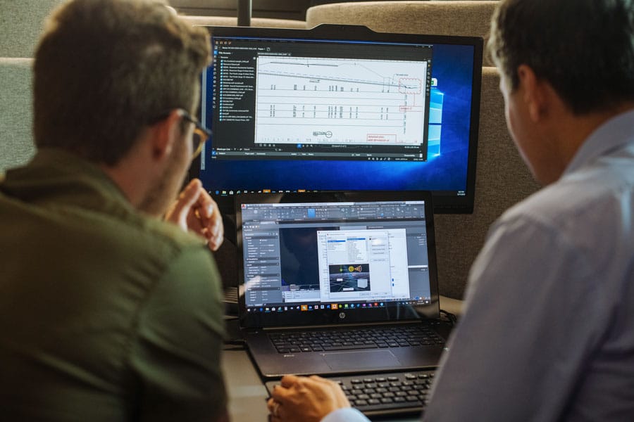 people working on construction files on computer