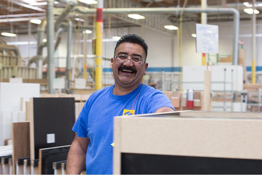 smiling man in woodwork manufacturing shop Mission Bell