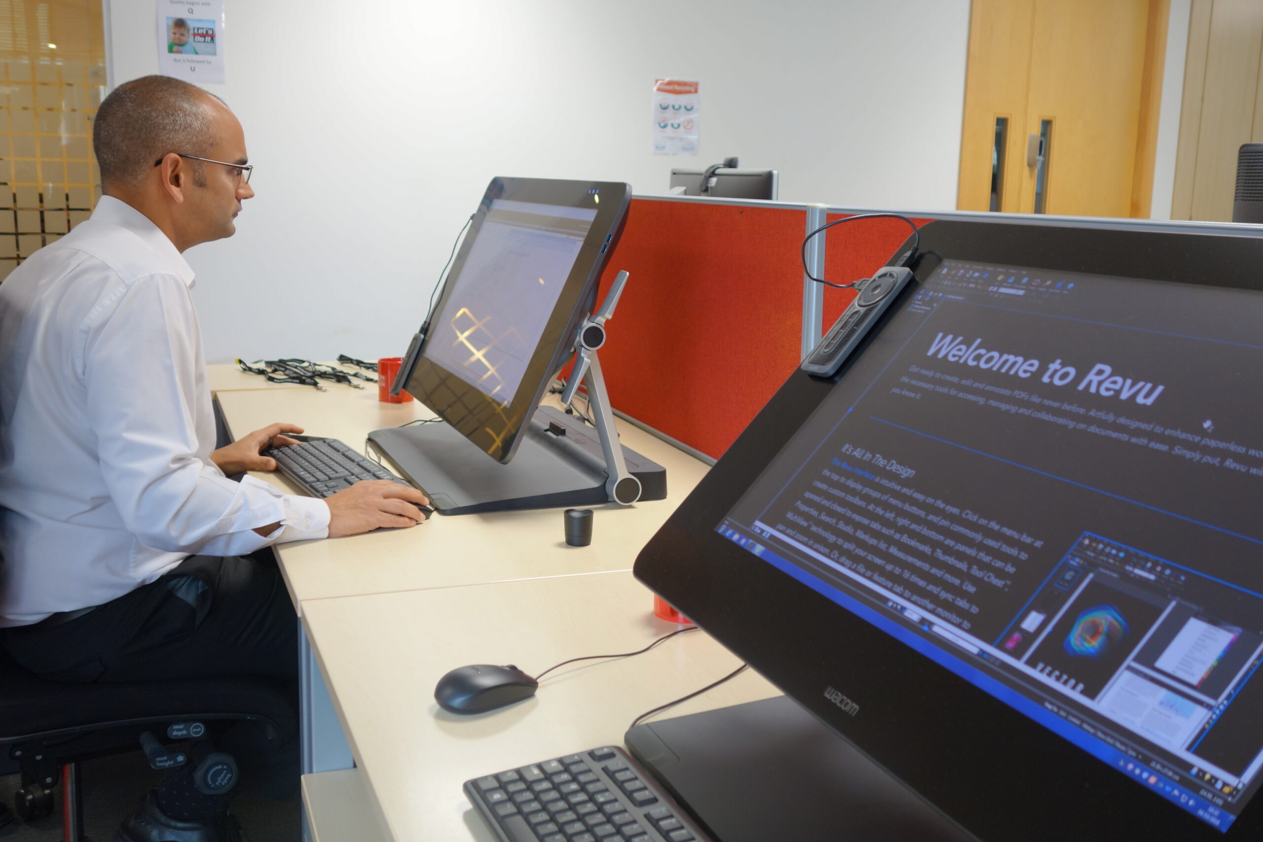 man working on computer, computer with Revu onboarding screen