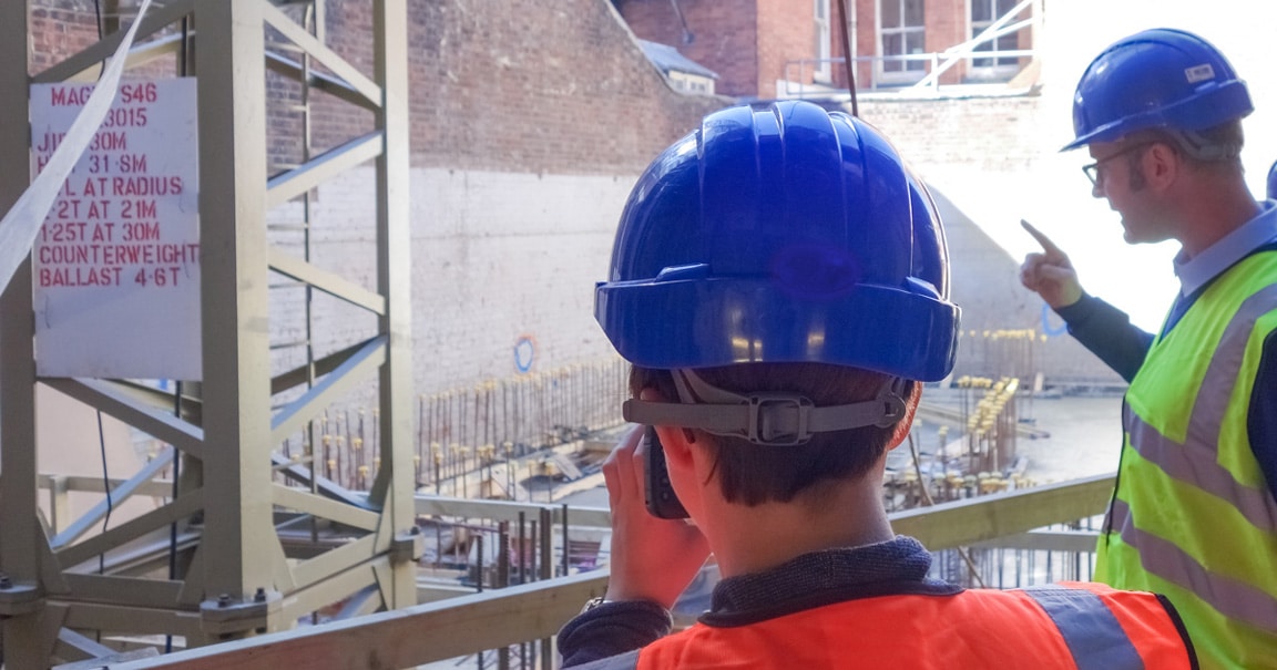 men wearing helmets on construction site