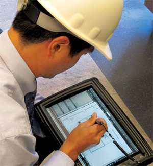 man with construction helmet working on device