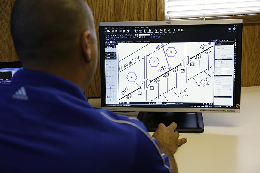 man in office working on Bluebeam construction software