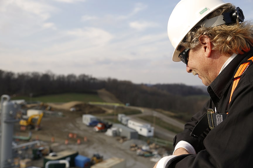 man wearing construction helmet looking at Bluebeam customer McCarl's job site