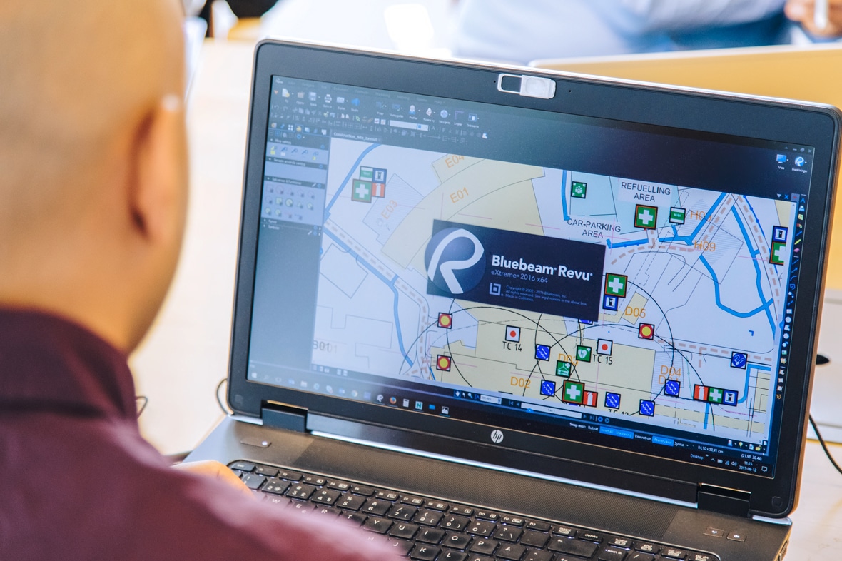 man viewing Revu software interface on laptop