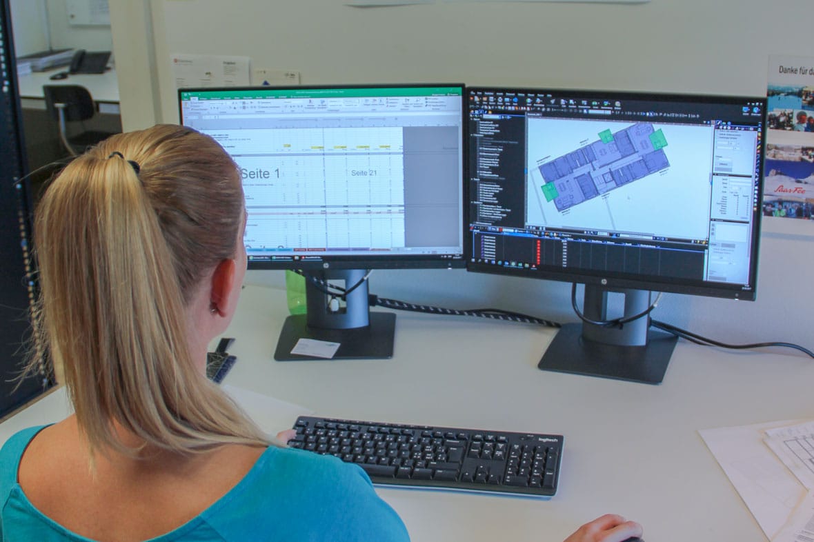 woman views construction drawing on computer