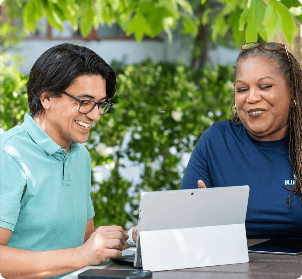 People looking at a laptop outdoors in Bluebeam office