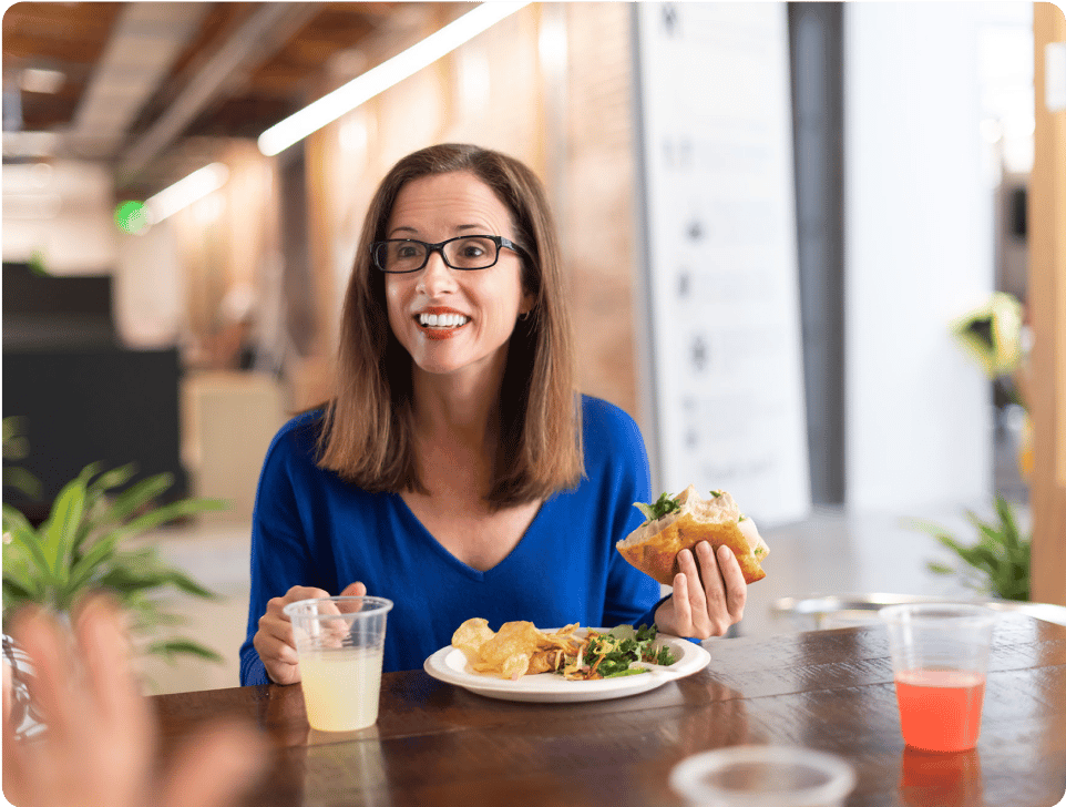 Bluebeam employee Staci sitting at lunch table with food