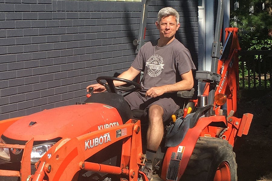 David Rekker, senior regional manager at Bluebeam, sits in a tractor
