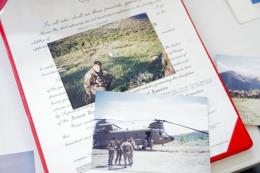 Three photos and a certificate from Ernesto's time with the Marine Corps