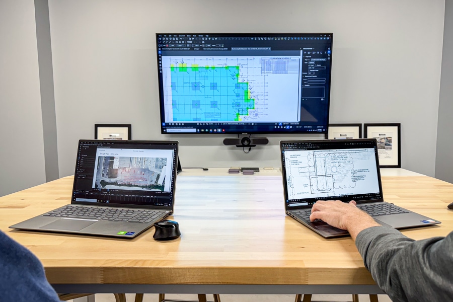 Bluebeam Revu on two laptops and a TV in a conference room.