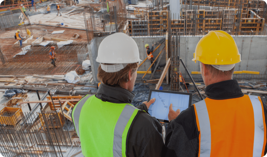 Construction workers use Bluebeam construction management tools while overlooking the jobsite