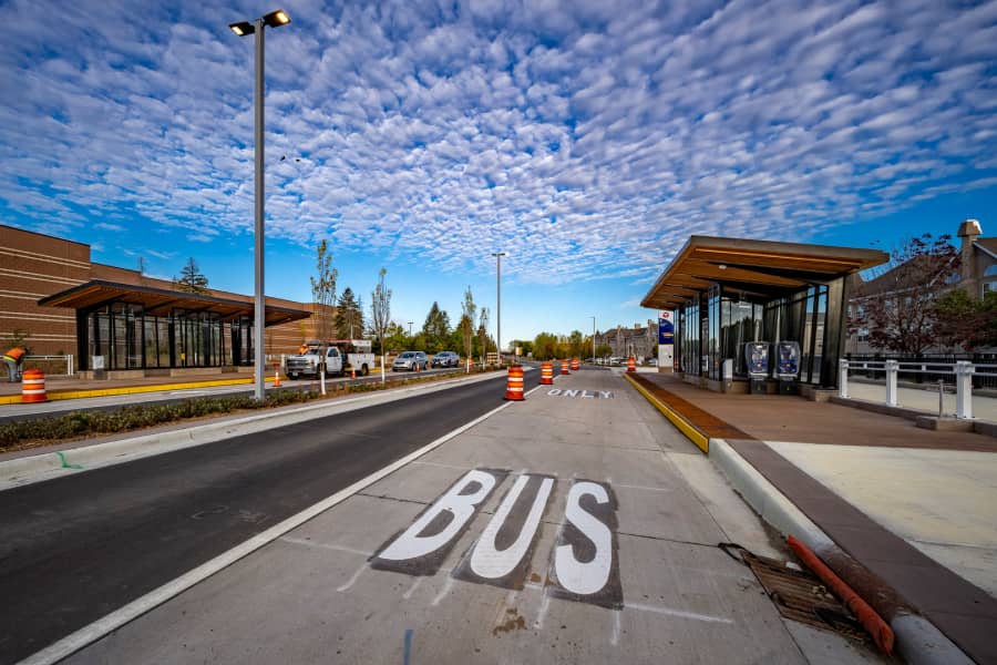 Transit facility showing newly constructed bus platform and shelters under a vivid sky