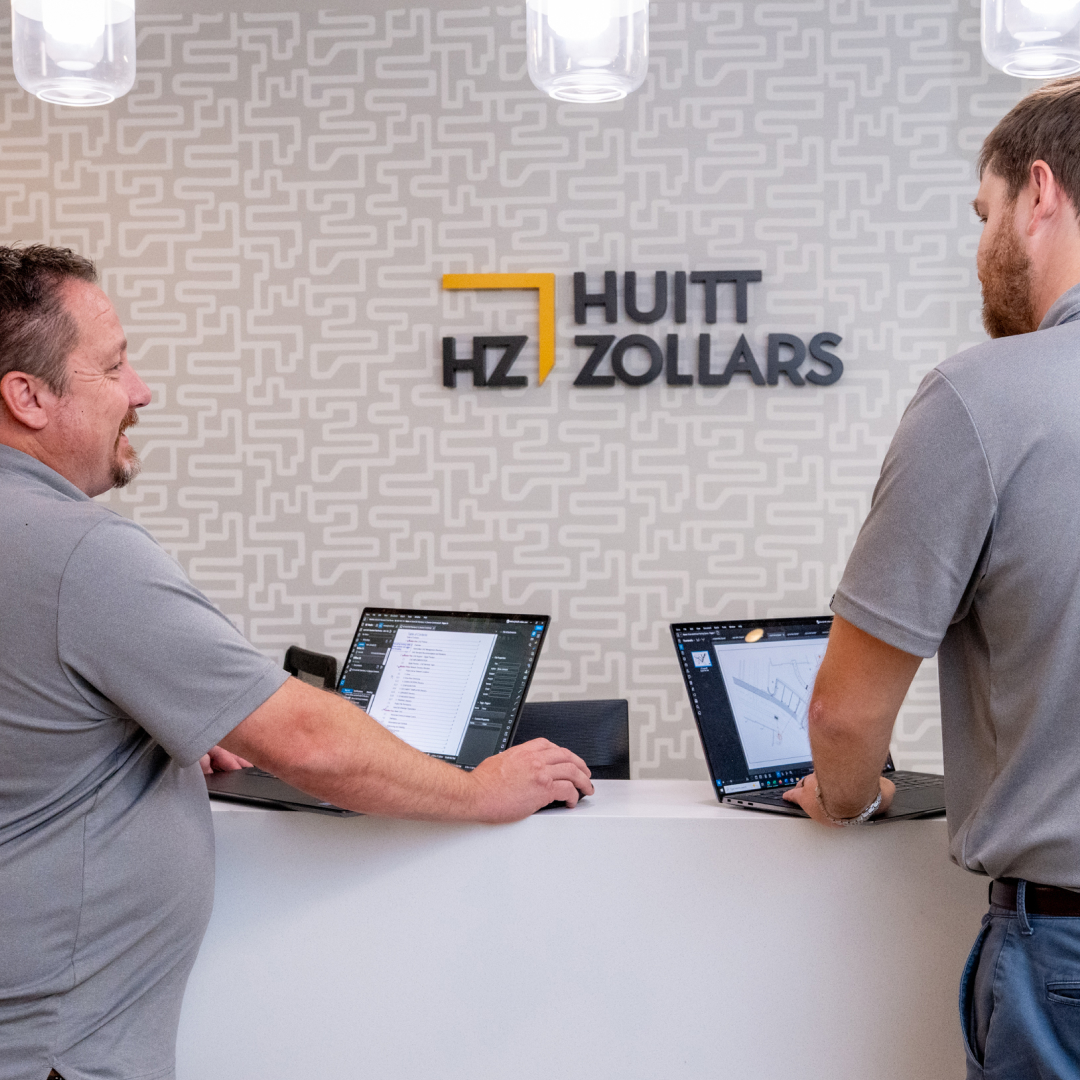 Aerial view of a jobsite with a wall being built.