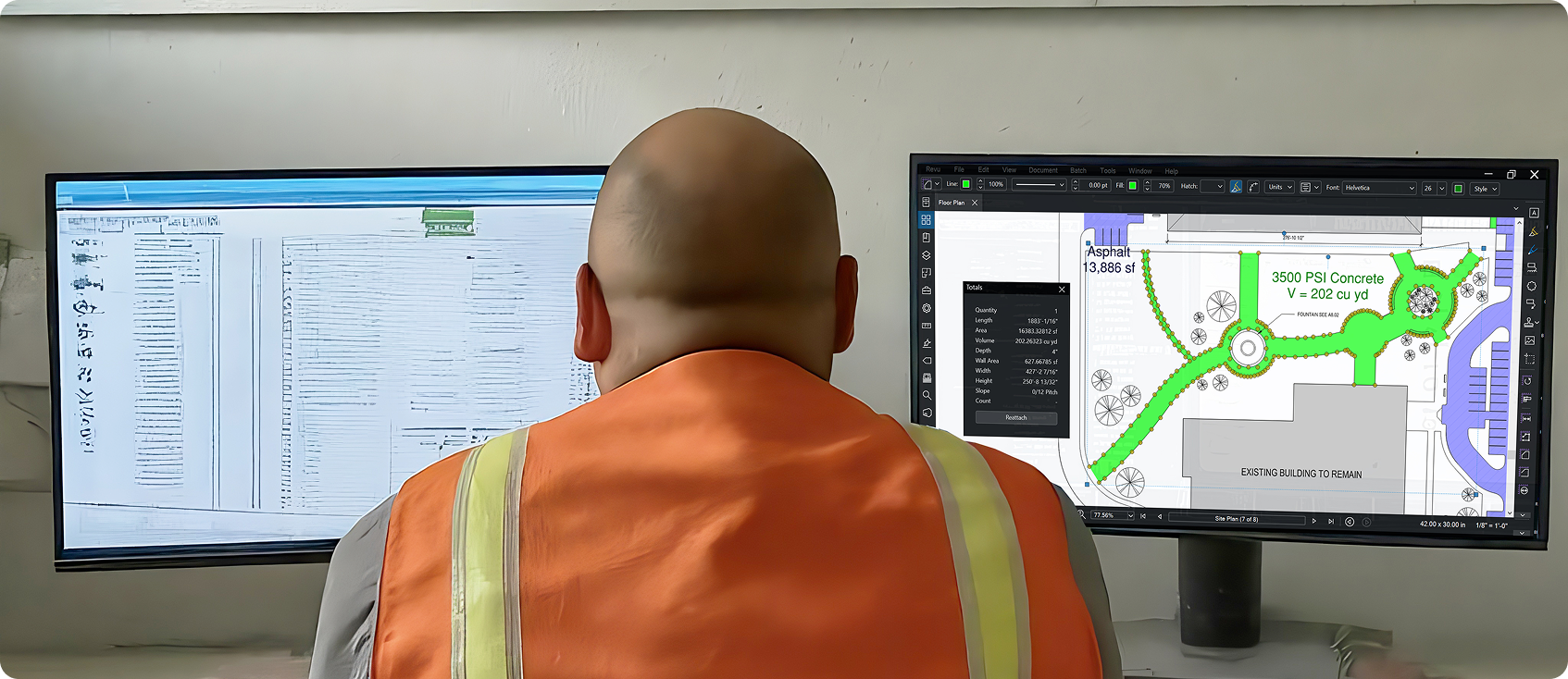  A person wearing an orange safety vest sits at a desk, looking at two computer monitors displaying construction documents and a site plan for detailed quantity takeoffs. 