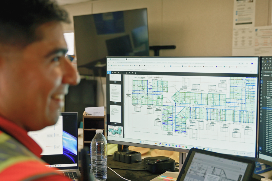 Construction worker using Bluebeam Revu on multiple screens