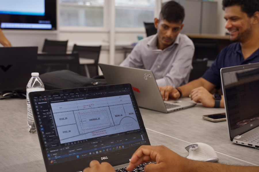 Closeup of Bluebeam Revu on a Fresno State student's laptop with the student''s classmates in the background