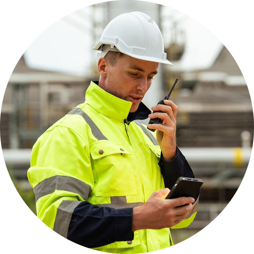 Construction worker speaking into walkie talkie