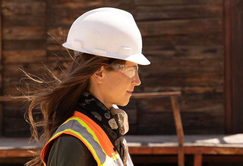 http://Profile%20of%20woman%20construction%20worker%20walking%20through%20old%20west%20town