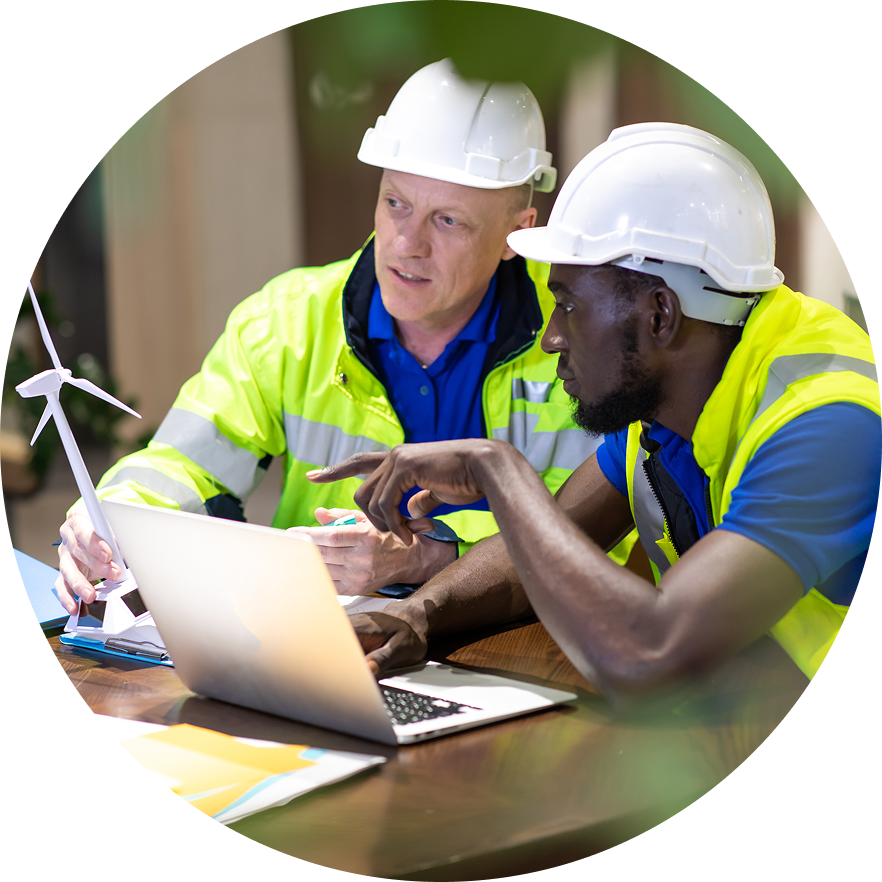 Two construction workers usinga laptop together