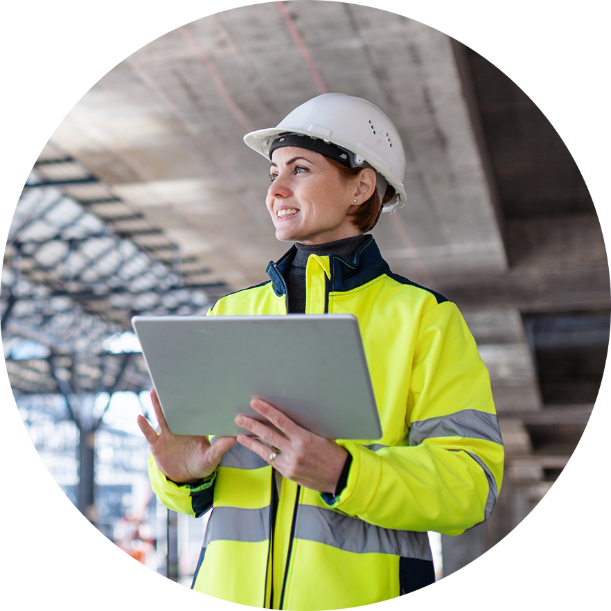 Construction worker looks up from tablet