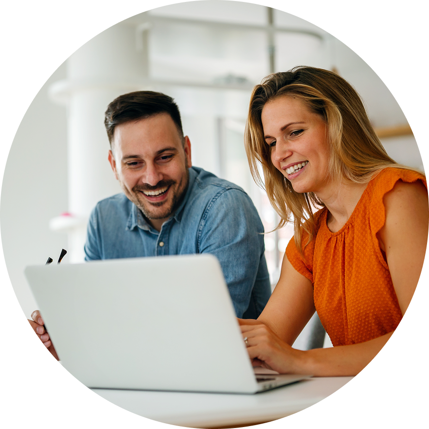 Two office workers looking at laptop together