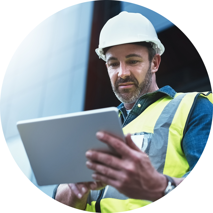 Construction worker looks down at tablet