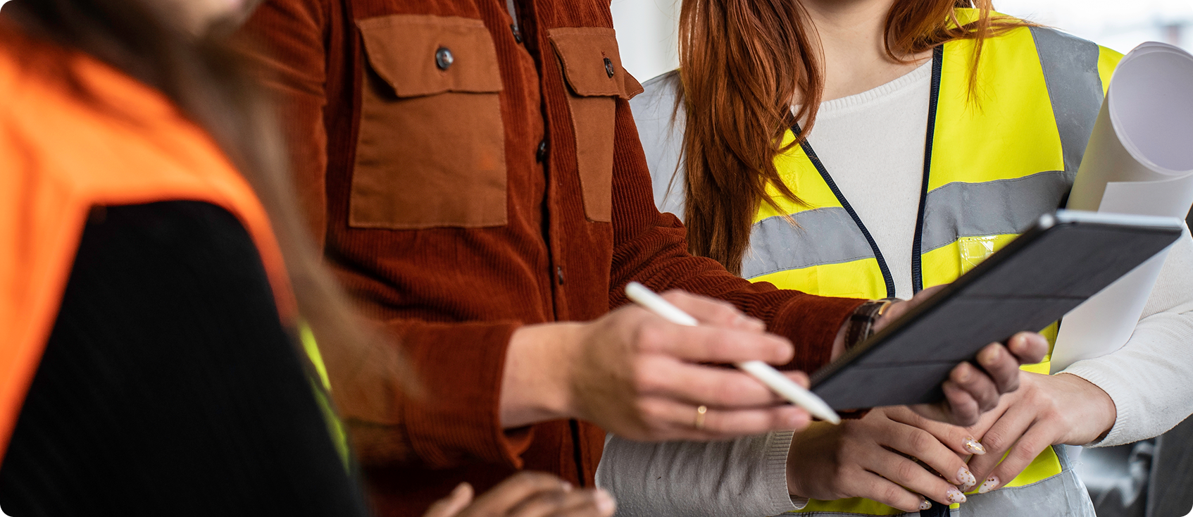  Three construction workers look at tablet 