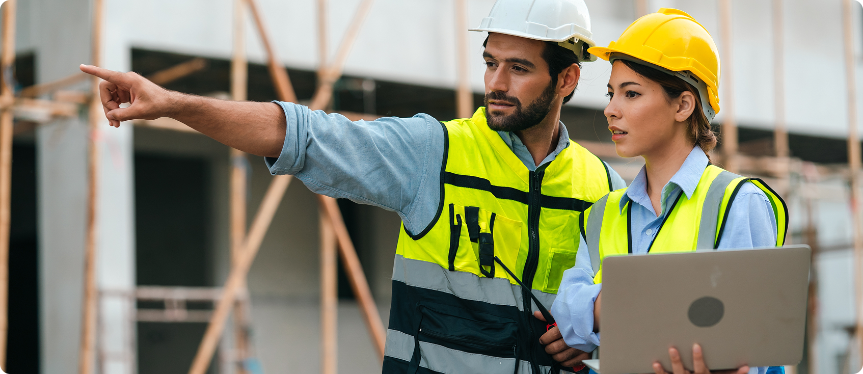  Construction worker points something out to colleague 