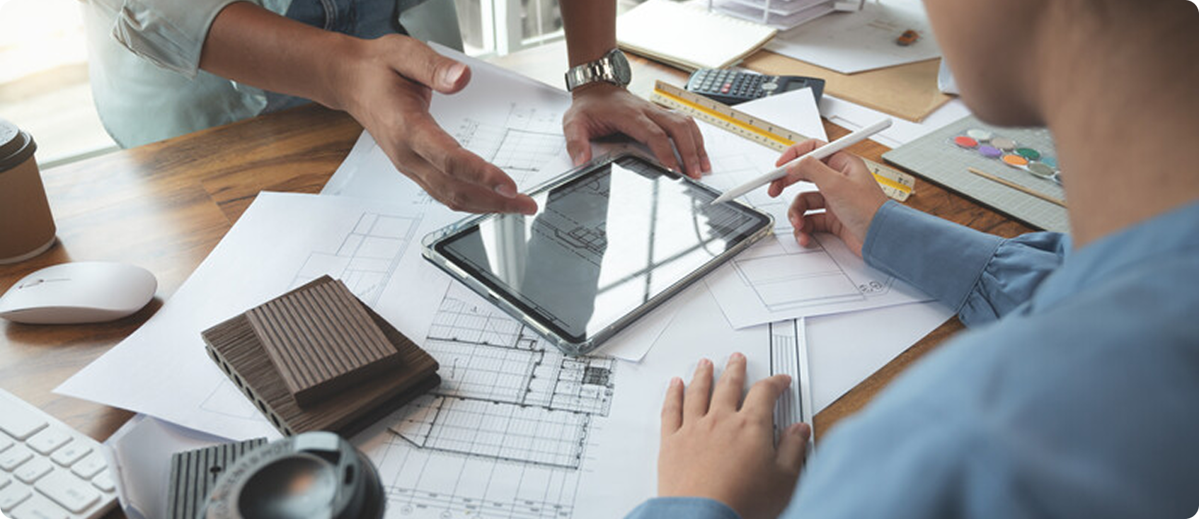  Two construction workers using a tablet and measuring tools together 