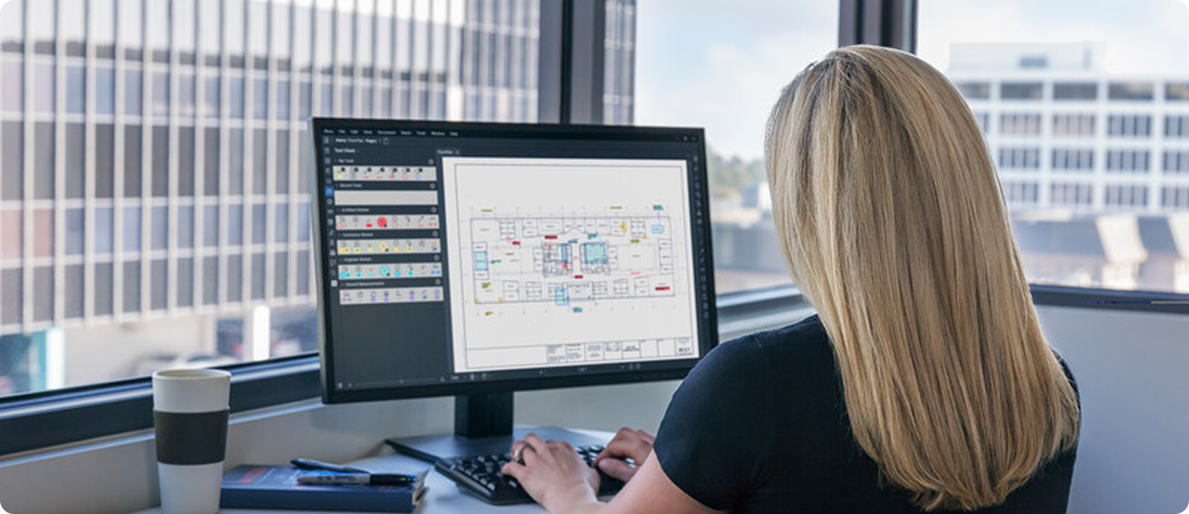  Woman using Bluebeam Revu in office 