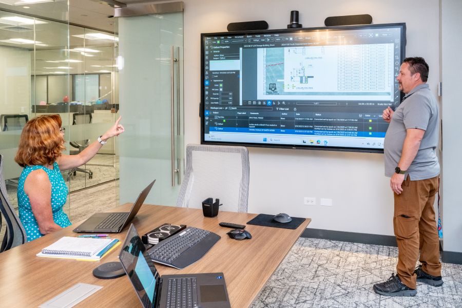 Huitt-Zollars employees work with Revu in a conference room